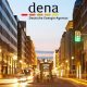 dena Logo vor abendlicher Stadtansicht